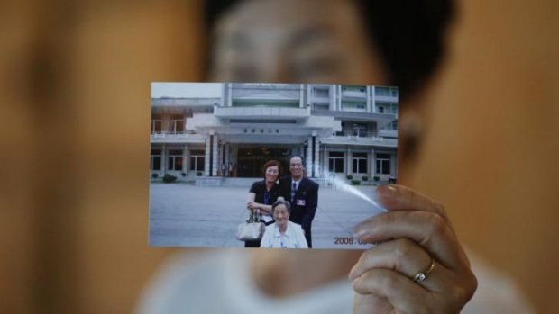 Kim Young-ja, the sister of Kim Young-nam, with a picture showing her abducted brother taken during a reunion in 2006.