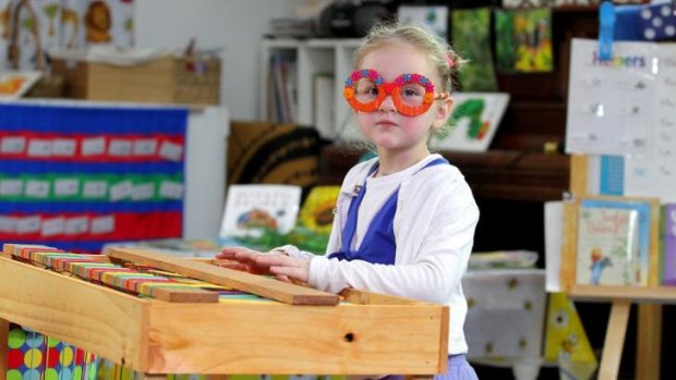 Caitlin Audibert, 4, from Brighton, plays the recycled keyboard.