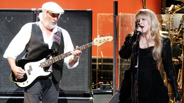 Cancer sufferer John McVie with Stevie Nicks onstage in 2009 Fleetwood Mac concert.