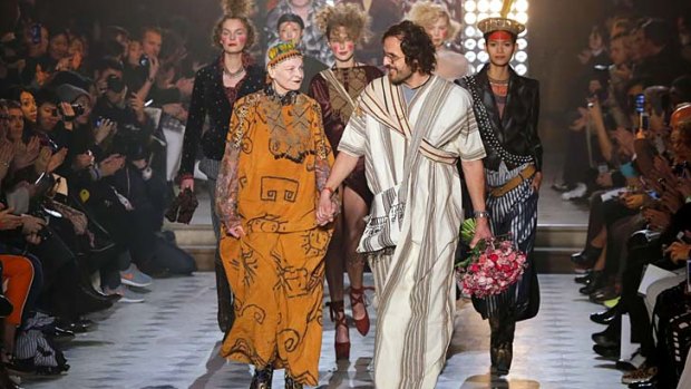 British designer Vivienne Westwood, left, and her husband Andreas Kronthaler acknowledge applause at the end of Westwood's ready-to-wear fall/winter 2014-2015 fashion collection presented in Paris.
