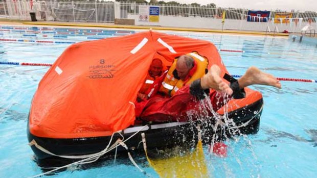 Welcome aboard . . . members of the Wild Oats crew XI practice loading up a life raft at the Drummoyne Swim Centre this week.