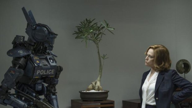 Sigourney Weaver as the chief executive of  a military weapons company with one of the robot cops her company is promoting.