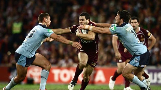 Greg Inglis attacks the Blues defensive line during game two of the State of Origin Series.