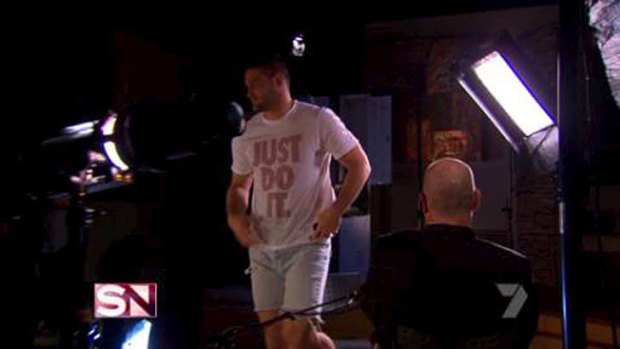 There he goes: Brendan Fevola storms out of the interview.