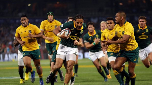 Hunted: Wallabies inside-centre Kurtley Beale sizes up South Africa's Courtnall Skosan during the Rugby Championship match at the Free State Stadium in Bloemfontein.