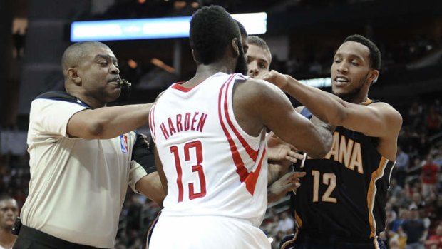 Referee Tony Brothers tries to break up a confrontation between Houston Rockets guard James Harden and Indiana Pacers new recruit Evan Turner in Houston. Both players received a technical foul.
