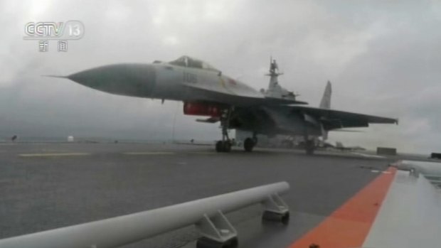 A J-15 fighter jet takes off from the flight deck of the aircraft carrier Liaoning during a drill in the South China Sea. 
