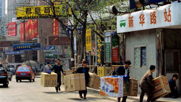 Porters unload goods.