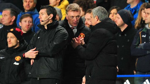 Manchester United manager David Moyes (centre) and Chelsea manager Jose Mourinho shake hands after Chelsea defeated United on Sunday.