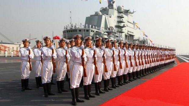 Tension: Sailors on parade in front of China's first aircraft carrier, which was in the confrontation with the USS Cowpen.