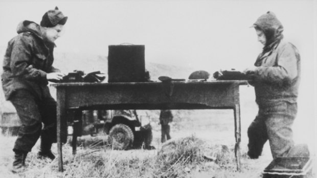 Harry Gordon (right), writing a story in Korea 1951. 