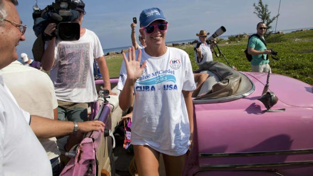 Chloe McCardel waves as she arrives to begin her swim to Florida from the waters off Havana, Cuba.