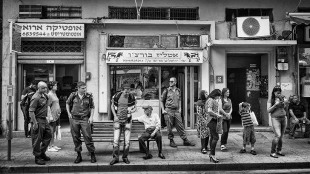 People wait for a bus, from Nathan Miller's book, <em>Somewhere in Jaffa</em>.