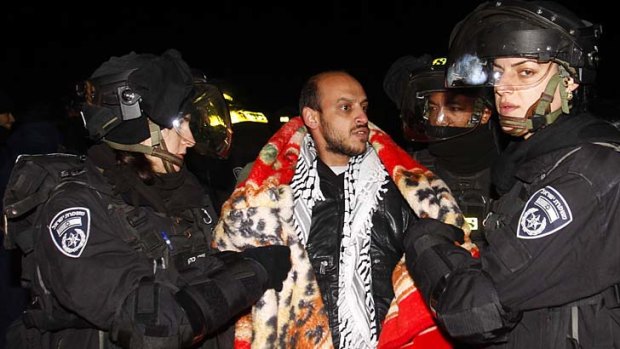 End of the road ... Israeli border police evict a Palestinian activist from an area known as E-1.