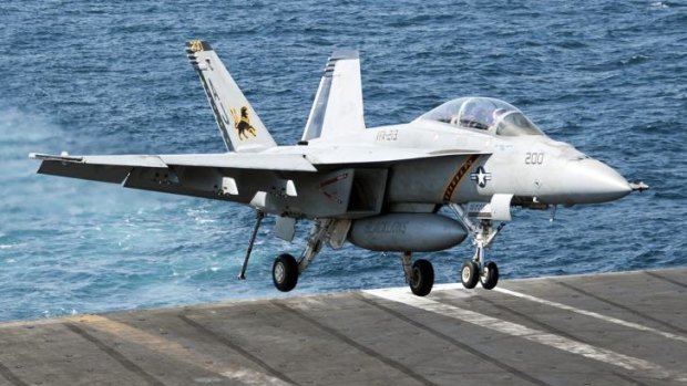 US Navy F/A-18F Super Hornet lands aboard the aircraft carrier USS George H.W. Bush in the Persian Gulf.