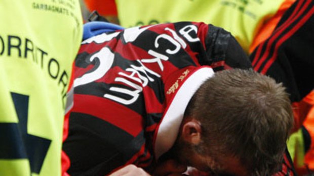 World Cup blow . . . David Beckham reacts after being injured at the San Siro stadium in Milan.