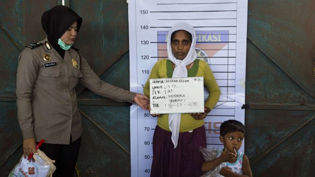 Rehena Begum, a rescued Rohingya mother from Myanmar, is photographed during an Indonesian police identification process at the confinement area in the fishing port of Kuala Langsa, in Aceh, on Monday.