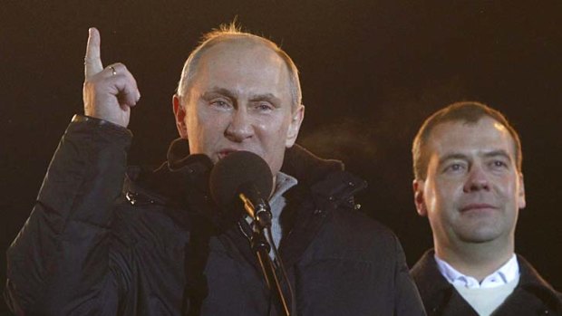 Claiming victory ... Vladimir Putin, flanked by President Dmitry Medvedev.