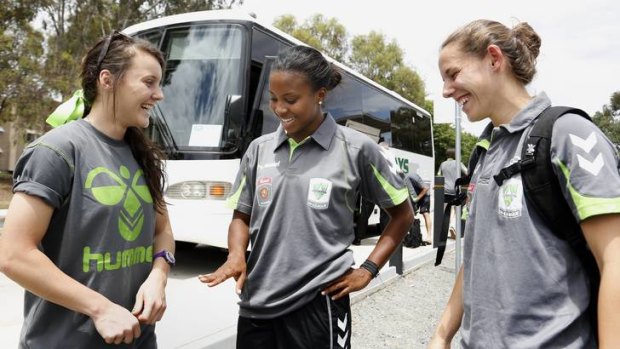 Canberra United recruit Nikki Washington, centre, chats with teammates Hayley Raso, left, and Nicole Sykes, right.