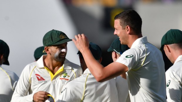Nathan Lyon (left) and Josh Hazlewood (right) celebrate Lyon's run-out of James Vince.