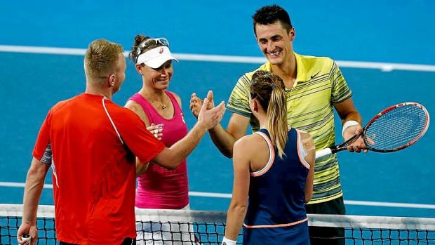 Poles apart: Grzegorz Panfil and Agnieszka Radwanska of Poland celebrate winning the second set in the mixed doubles match against Sam Stosur and Bernard Tomic of Australia.