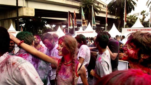 A place of many colours … people are covered in dyes as part of the Indian Holi Mahotsav festival at Darling Harbour yesterday.
