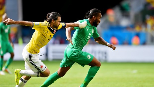 Didier Drogba of the Ivory Coast runs past Mario Yepes of Colombia during their Group C. Columbia won 2-1 in a thriller.