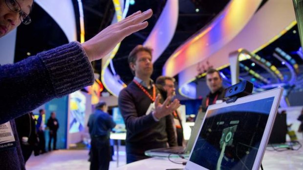 Convention attendees test out Intel's Creative Interactive Gesture Camera development kit.