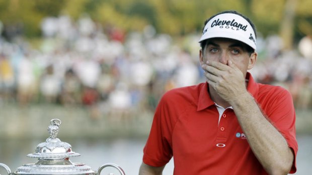 Stunned ... Keegan Bradley reacts with the Wanamaker Trophy on the 18th green.