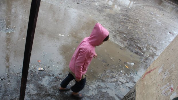 A child plays in the sodden Serres refugee camp in northern Greece. 