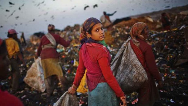 Indian children forage at a rubbish tip.