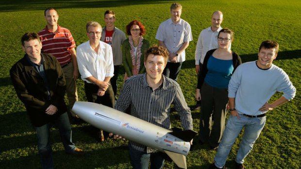 The University of Queensland's Scramspace team - Russell Boyce, Brad Sharp, Paul van Staden, Michael Creagh, Bianca Capra, Sandy Tirtey (Holding model), Adrian Pudsey, Melrose Brown, Amy Dedman and Igor Dimitrijevic - prior to leaving for Norway.