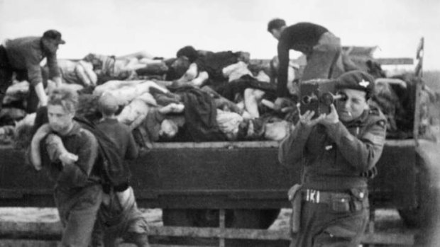 Army Film and Photographic Unit cameraman Sergeant Mike Lewis, filming at Bergen-Belsen concentration camp on 24 April 1945.