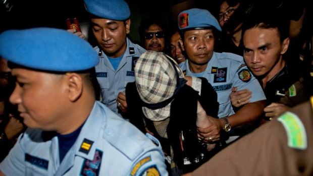 Masked from the glare of the cameras ... Schapelle Corby is released from Kerobokan prison in Bali.