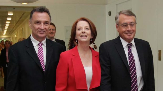 Prime Minister Julia Gillard with Trade Minister Craig Emerson (left) and Treasurer Wayne Swan (right).