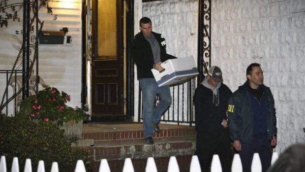 FBI agents remove evidence from the Brooklyn, New York residence of Rabbi Mendel Epstein, who was among four Orthodox Jewish rabbis and one of their sons who were indicted.
