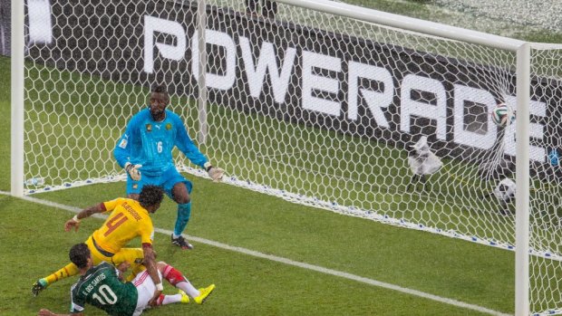 Giovani dos Santos of Mexico puts the ball in the net but the goal was disallowed due to an offsides call as goalie Charles Itandje and Cedric Djeugoue look on.