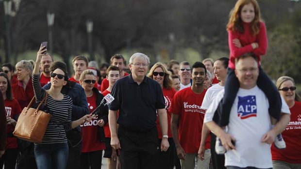 A little less zip: Kevin Rudd and supporters walk around Lake Burley Griffin on Thursday.