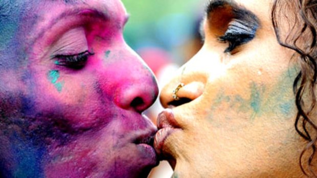 A eunuch kisses another member of the transgender, gay and lesbian communities as they celebrate the Indian court decision.