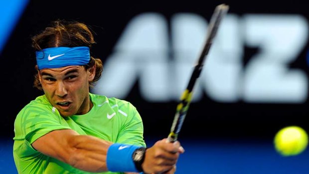 In charge: Rafael Nadal goes for a shot on the way to his victory over Roger Federer last night.