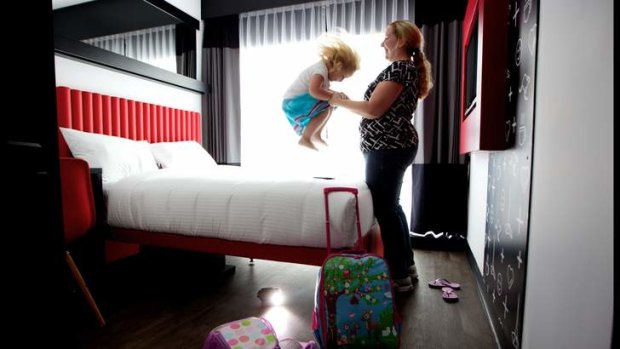 Sarah Keis plays with daughter Charlotte, 3, in their Tune Hotel room.