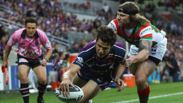 The Storm's Matt Duffie goes over the line to score a try for Melbourne.