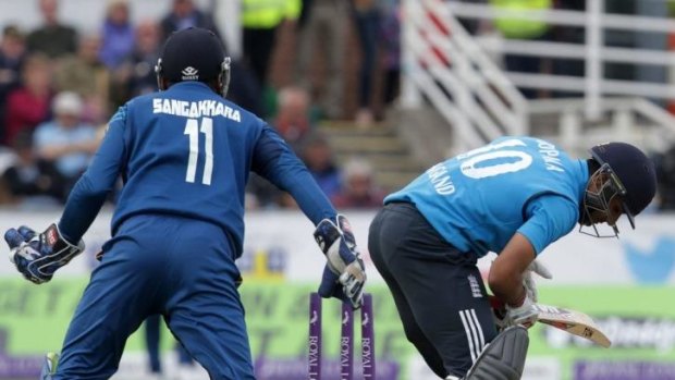 Sri Lanka's Kumar Sangakkara (L) looks on as as England's Ravi Bopara attempts a stroke.