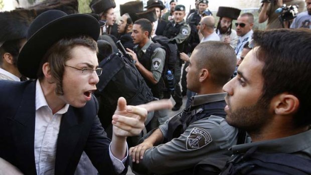 Protest ... police struggle face ultra-orthodox Jews at a rally in Jerusalem.