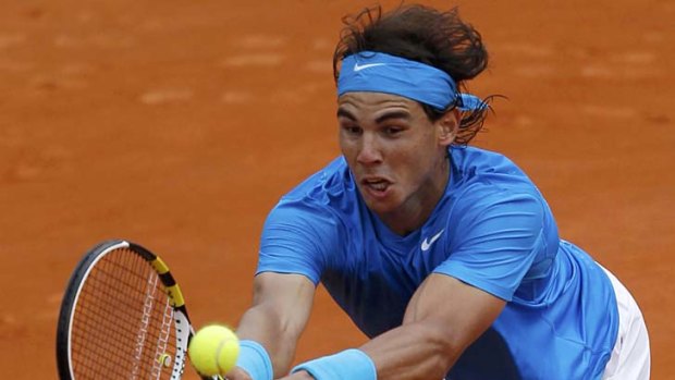 Rafael Nadal stretches to effect a return to Ivan Ljubicic.