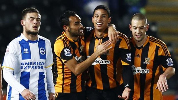 Quarter-final bound: Hull City's Curtis Davies (second from right) celebrates his goal against Brighton with Ahmed Elmonhamady and Matty Fryatt.