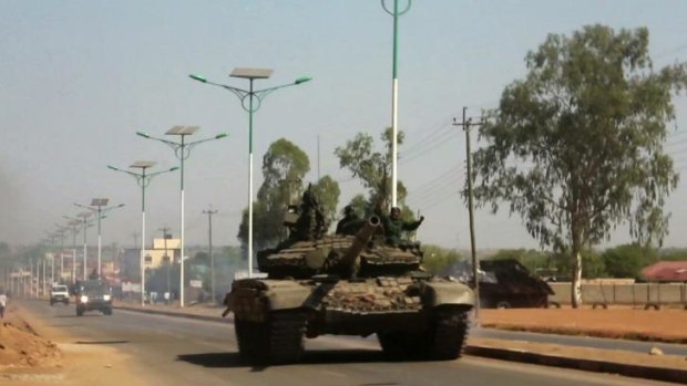A military tank patrols along one of the main roads in the South Sudanese capital Juba after the curfew was declared.