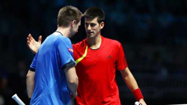 Robin Soderling (left) is congratulated by Novak Djokovic at the ATP World Tour Finals.