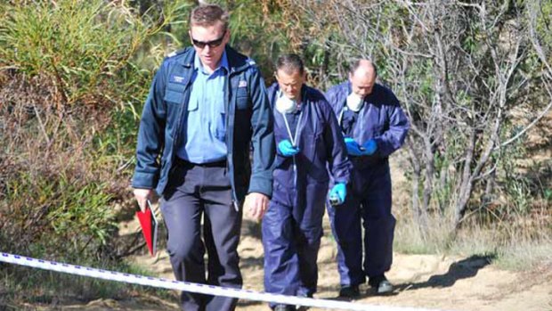 Police forensic officers in Two Rocks bushland where the missing wheelie bin of Craig Puddy was found.