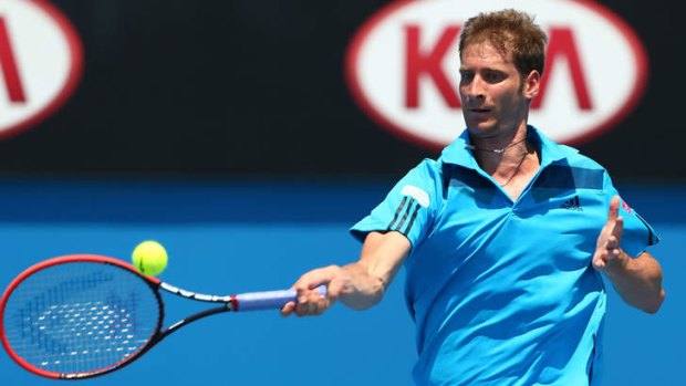 Florian Mayer of Germany in action against Jerzy Janowicz of Poland during day five of the 2014 Australian Open.